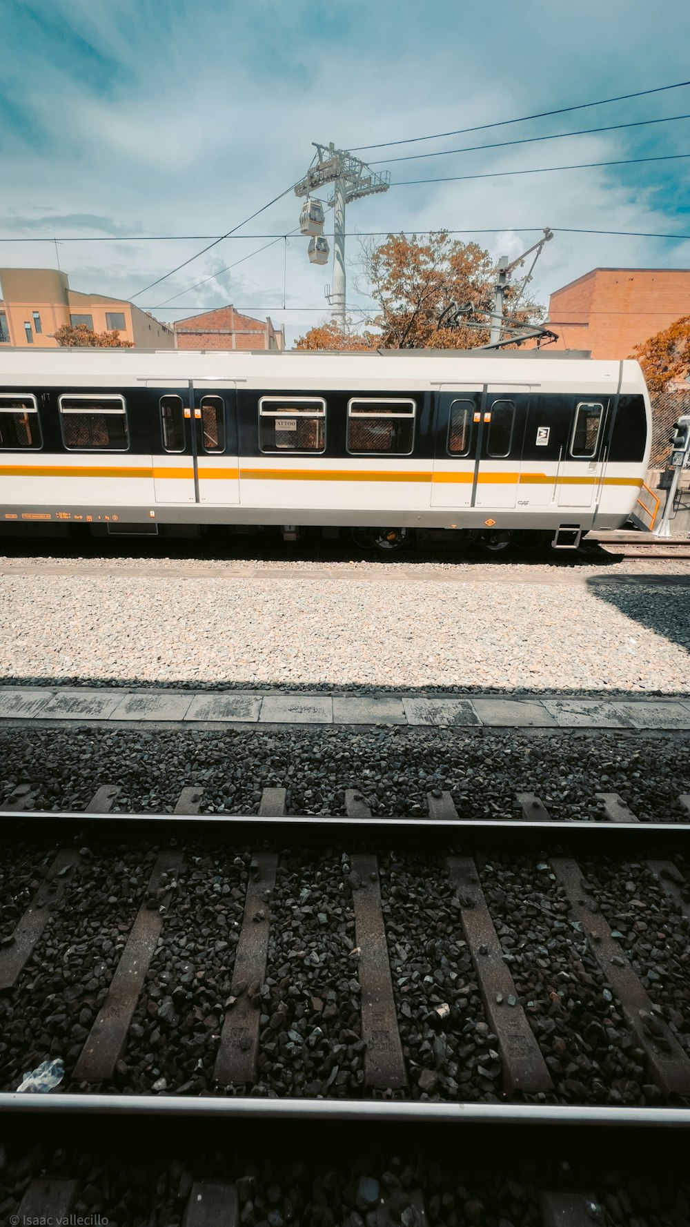 a train on a train track near a building