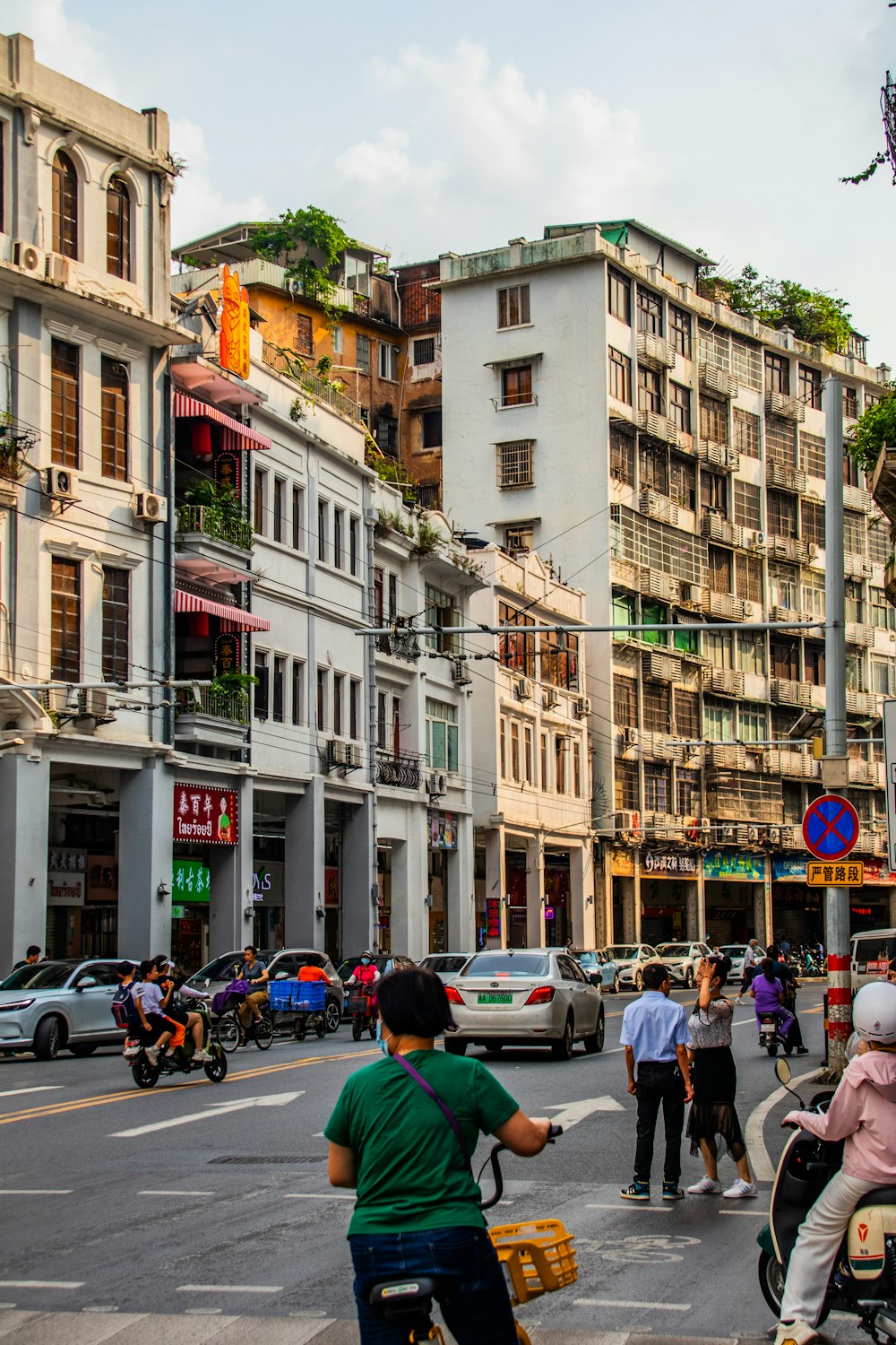 a group of people riding scooters down a street