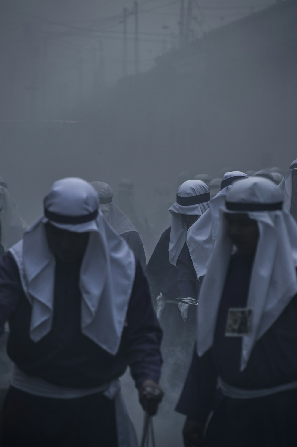 a group of people walking down a foggy street