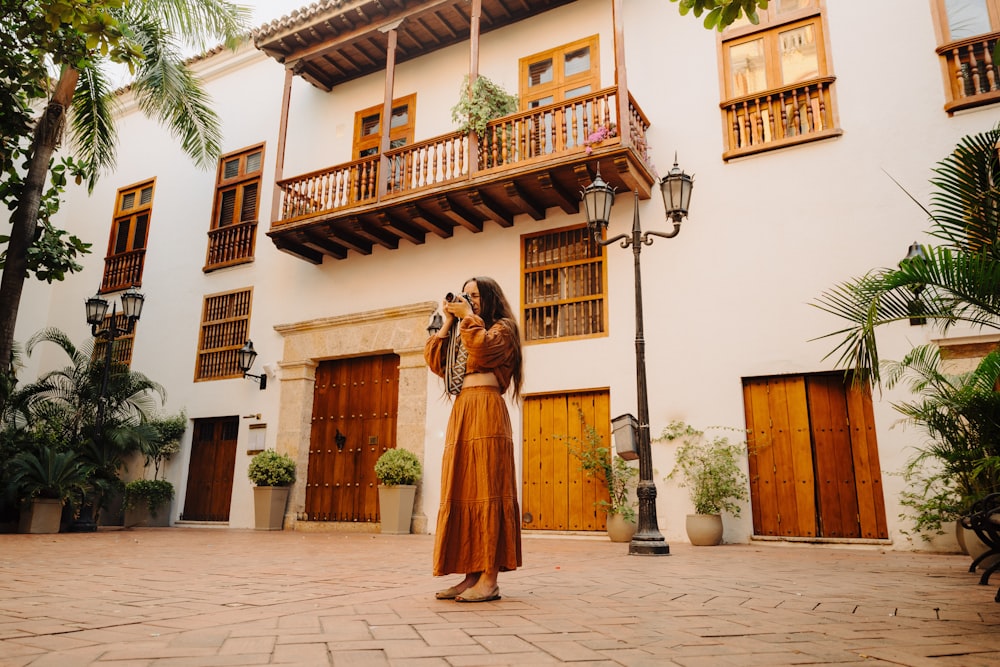 a woman standing in front of a white building