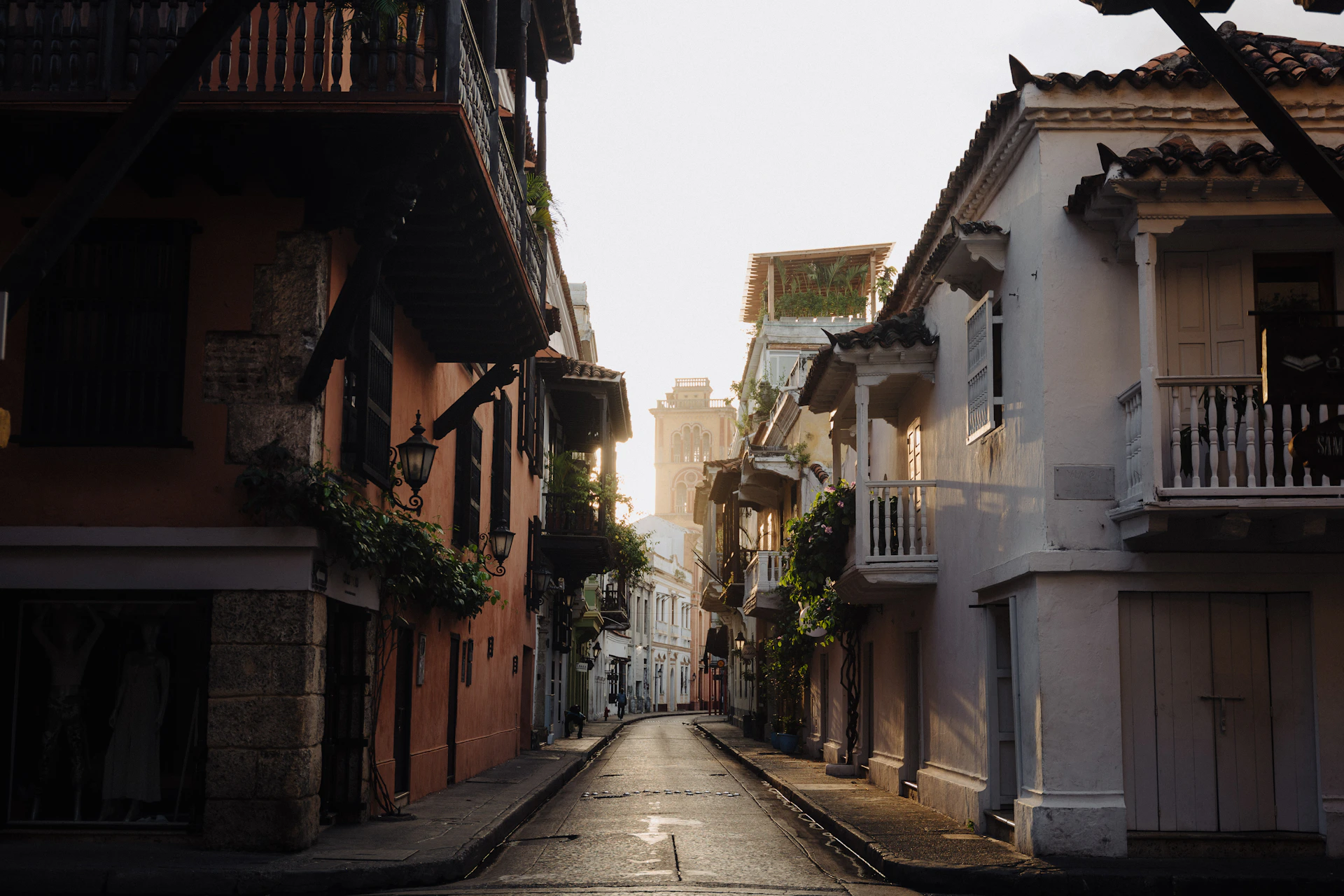 a narrow city street lined with tall buildings