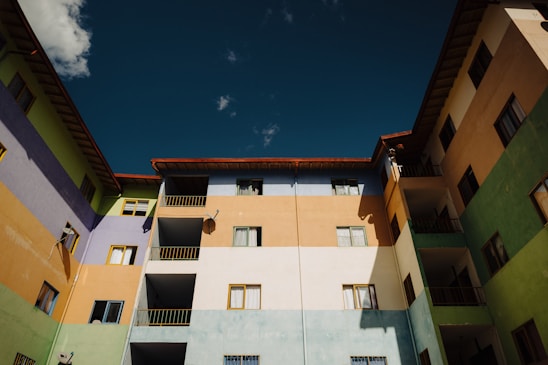 Cozy apartment building with friendly tenants enjoying a sunny courtyard.