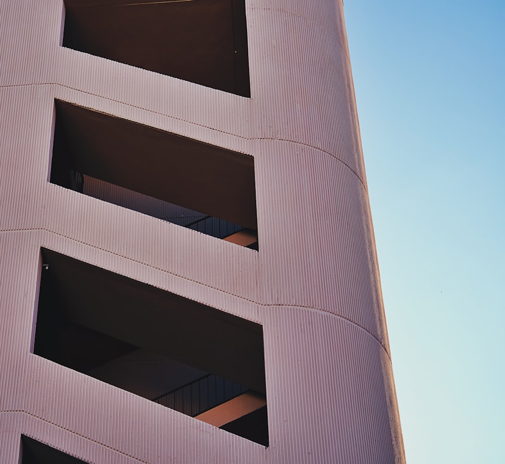 a tall building with two balconies on top of it