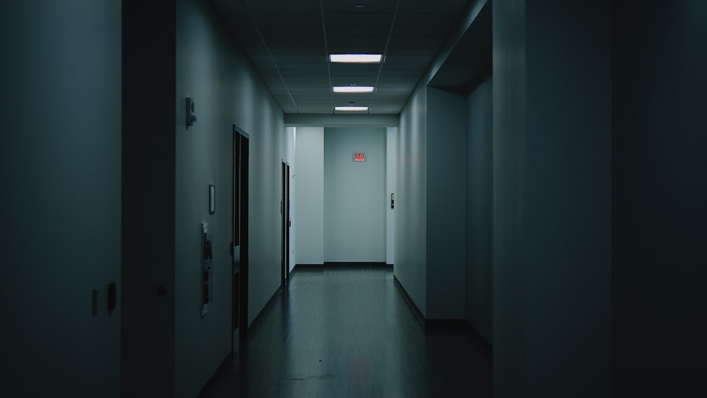 a long hallway with a light at the end of it