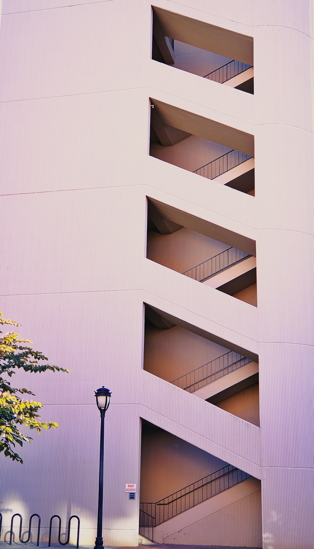 a tall building with a spiral staircase going up it's side