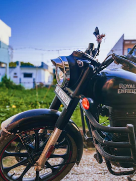 A sleek custom Royal Enfield with matte black finish and chrome details on a city street.