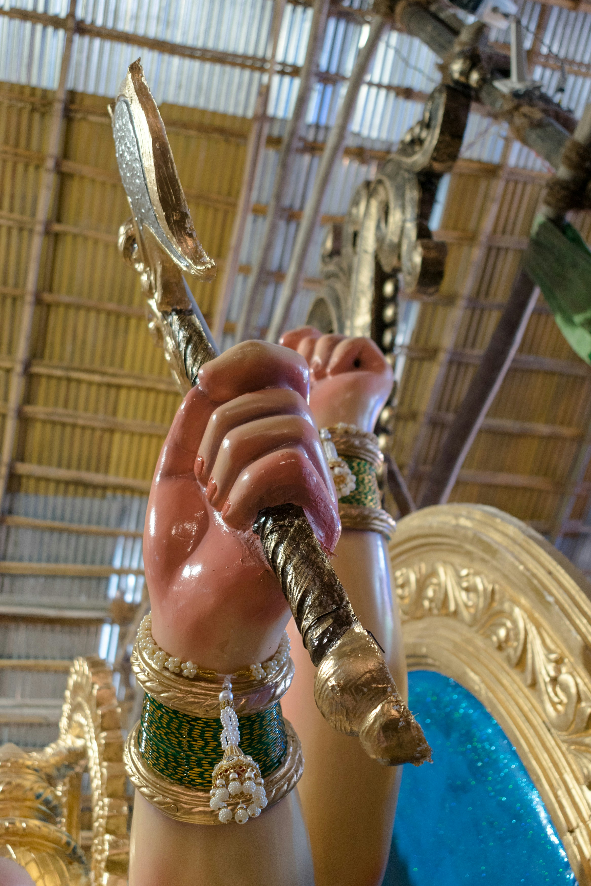 a close up of a statue of a person holding a wand