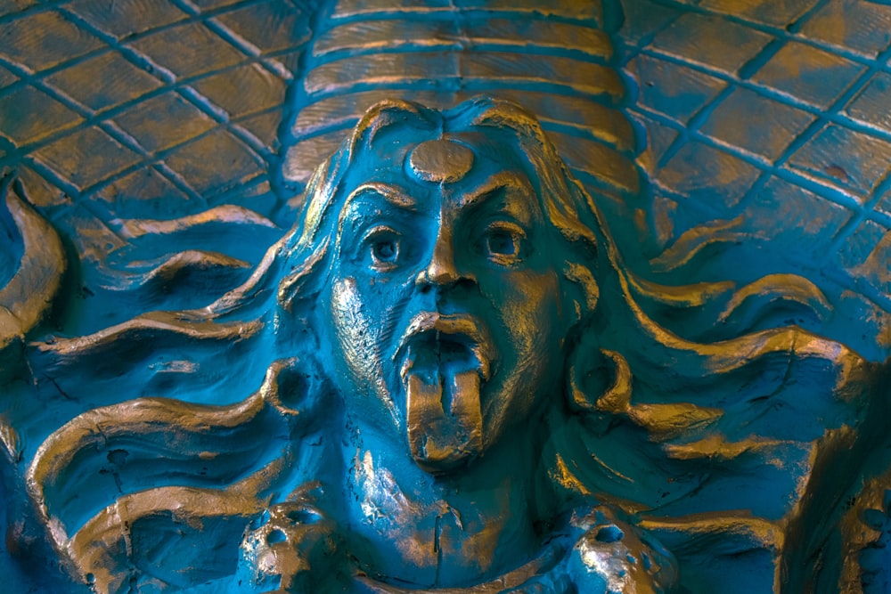a close up of a statue of a person with a hat