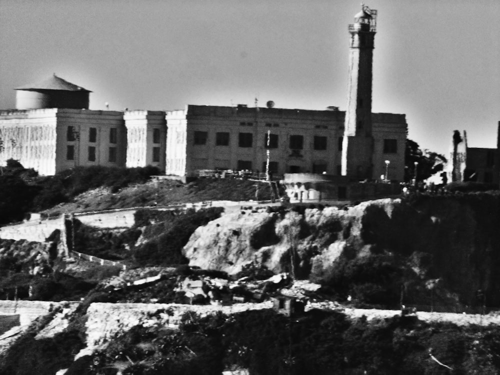 a black and white photo of a building on a hill
