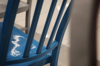 Close-up of a vibrant blue knee pad with textured anti-slip surface resting on a wooden floor.