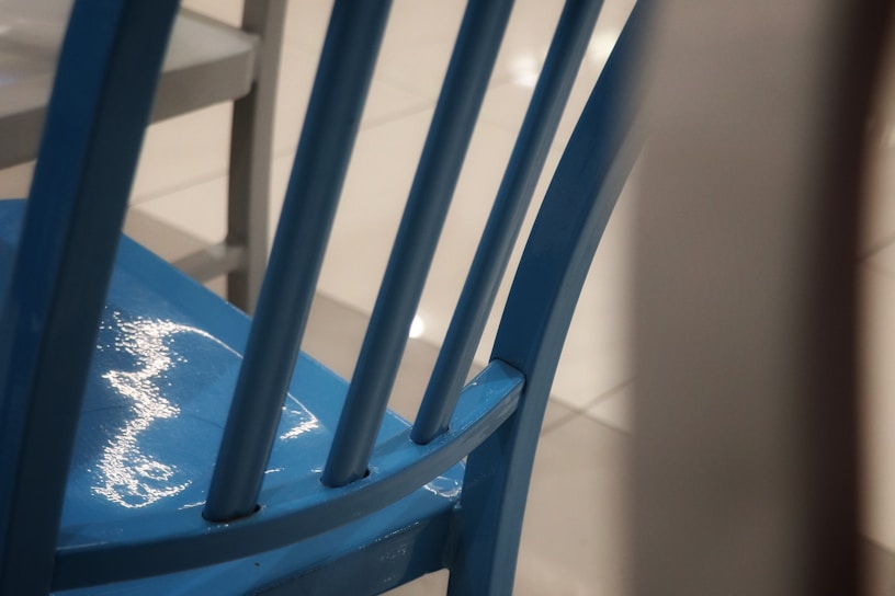 Close-up of a vibrant blue knee pad with textured anti-slip surface resting on a wooden floor.