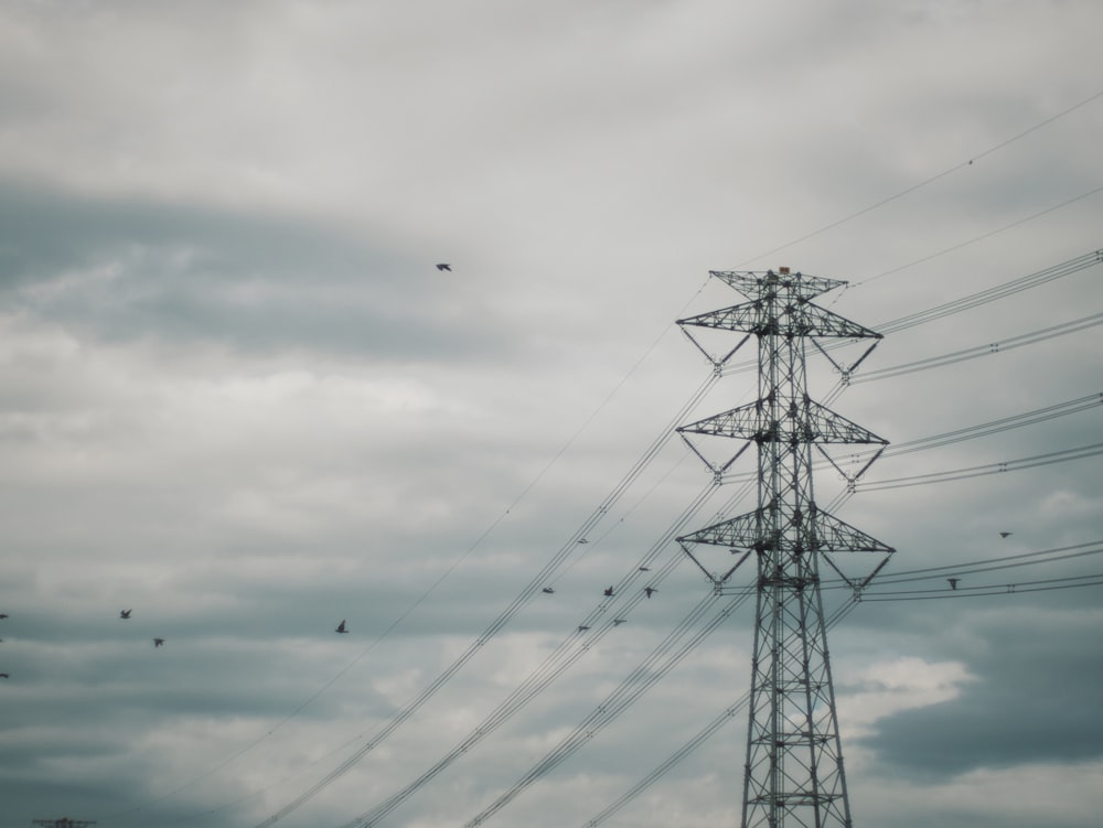 a tall tower with lots of power lines on top of it