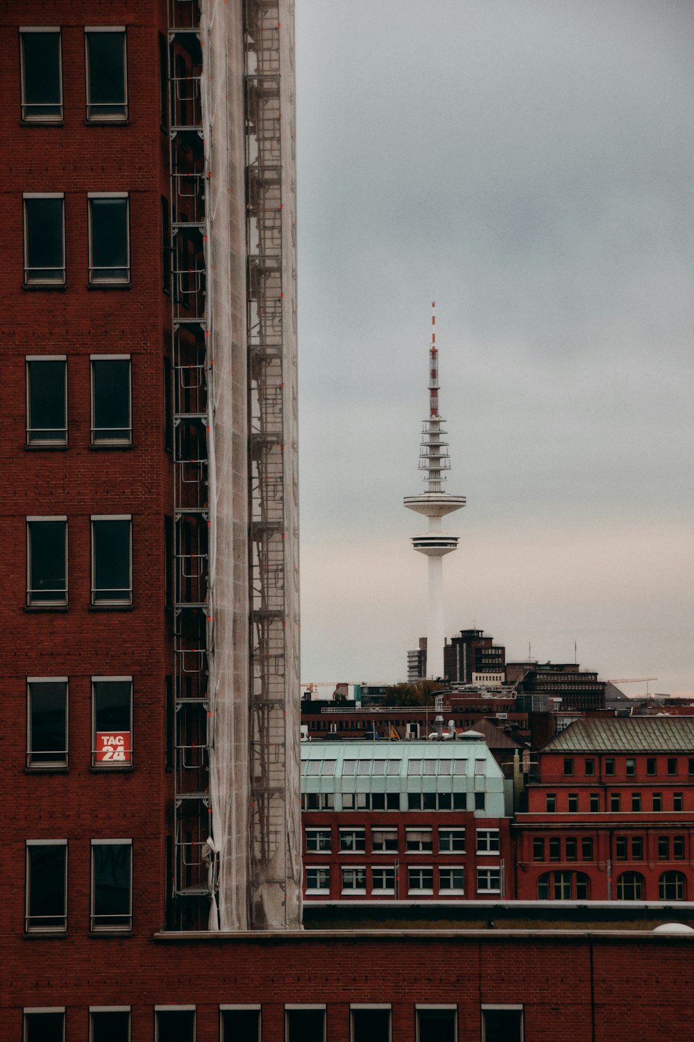 a red brick building with a tower in the background