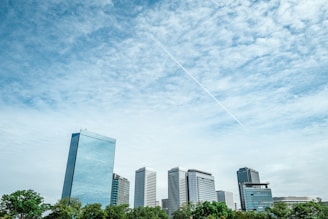a plane flying in the sky over a city