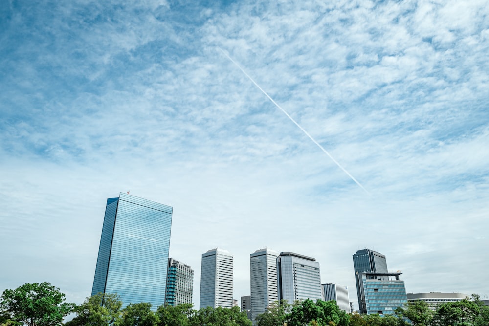 a plane flying in the sky over a city