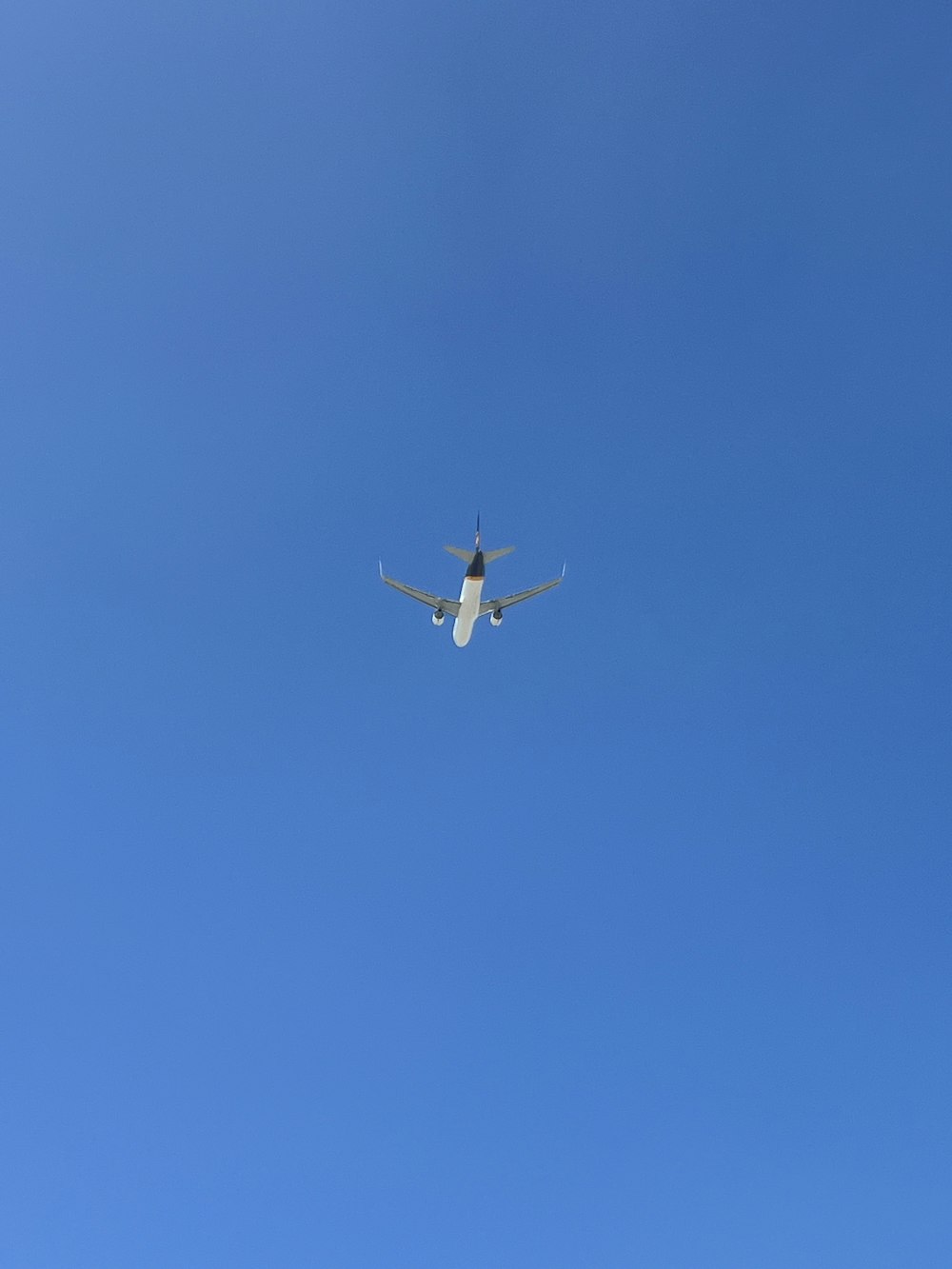 an airplane is flying in the blue sky