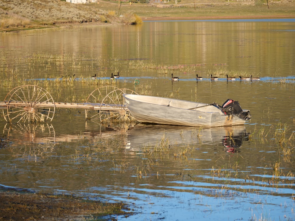 a small boat floating on top of a lake