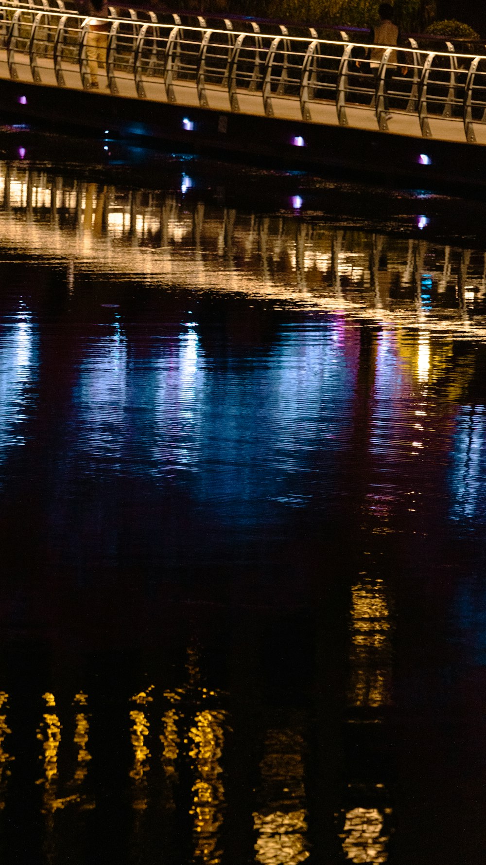 a bridge over a body of water at night