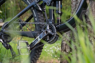 A close-up of mountain bike frame parts laid out on a wooden workbench.