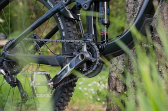 Close-up of mountain bike gears and accessories laid out on a wooden table.