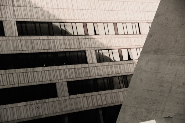 Architectural detail of a curved concrete facade with shadows