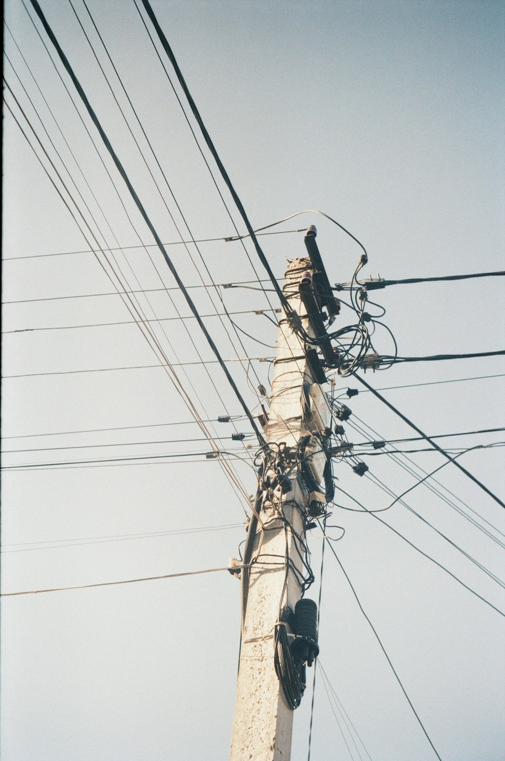 a telephone pole with a bunch of wires attached to it