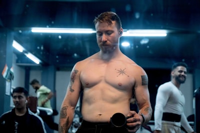 A group of diverse social media creators filming content at a trendy gym in Rome.