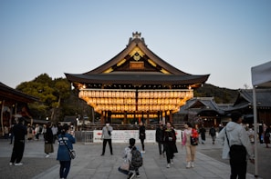 Evening view of a temple glowing warmly with lanterns and candles