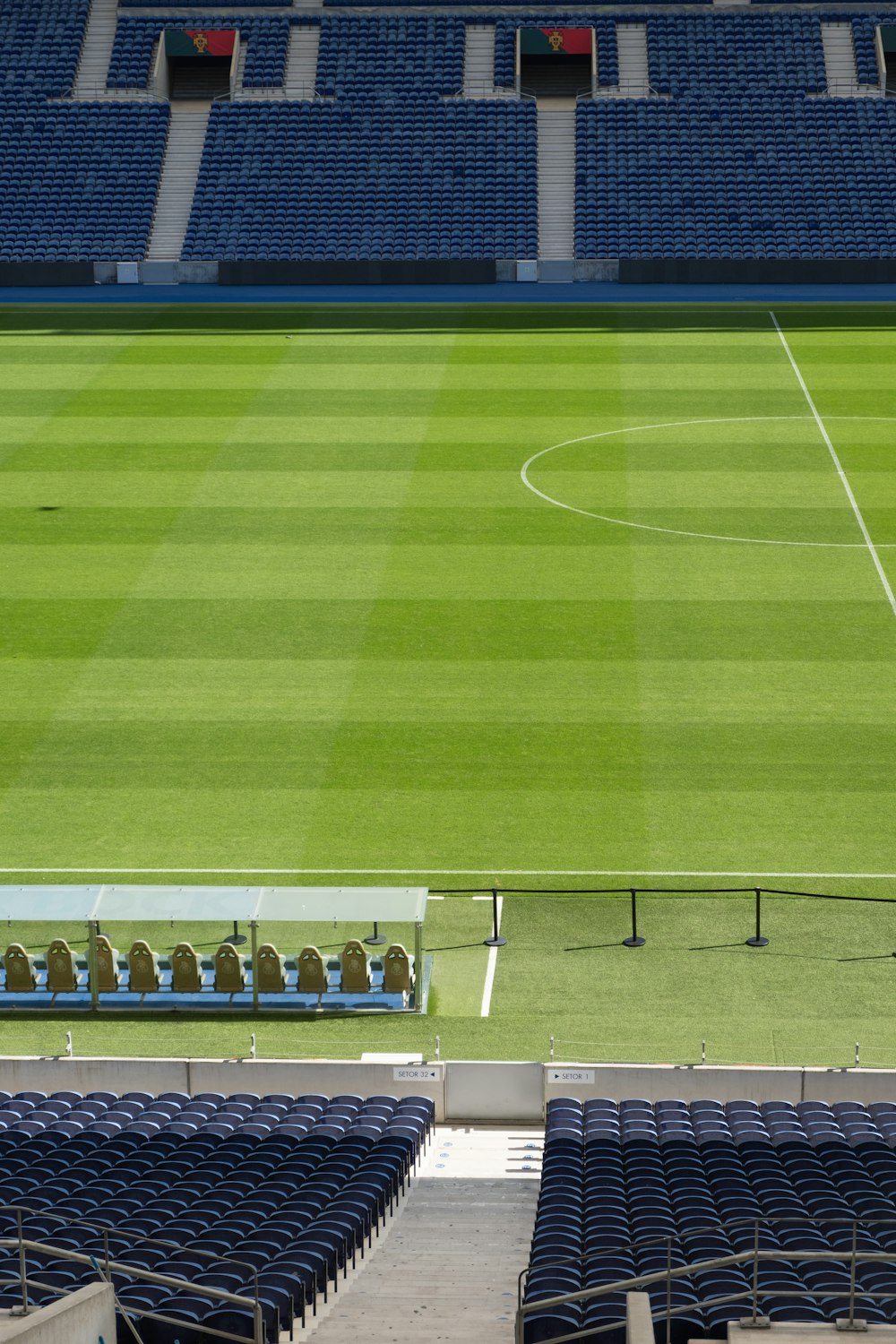 an empty soccer field with a row of seats