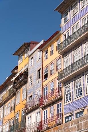 Historic Spanish architecture with colorful tiles and wrought iron balconies bathed in warm sunlight.