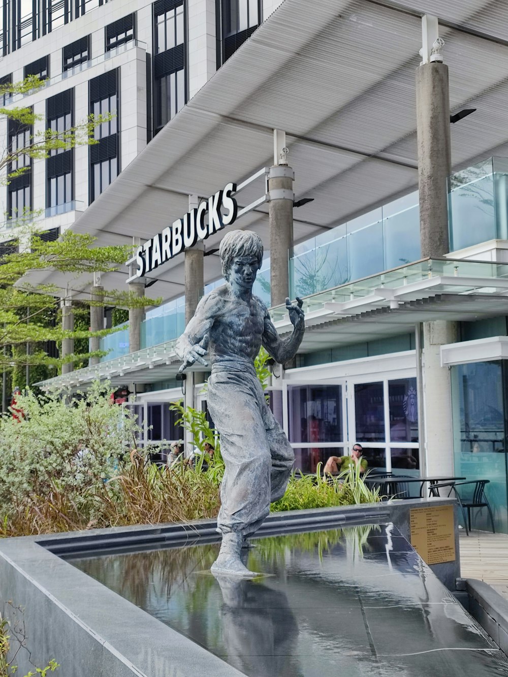 a statue of a boy holding a baseball bat