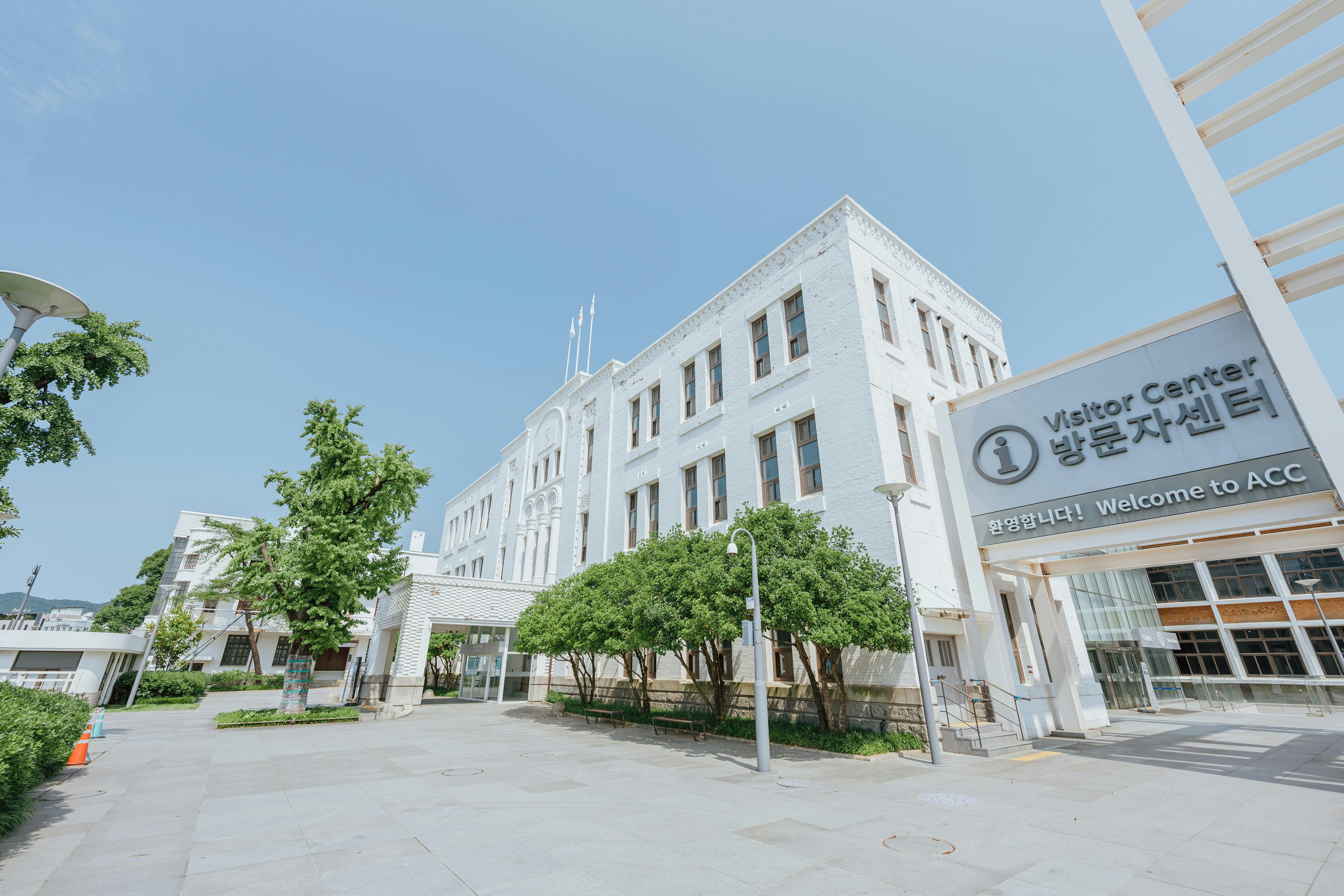 a large white building with trees in front of it