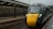a yellow and black train traveling down train tracks