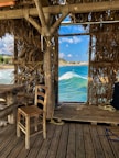Interior of a nature beach hut featuring rustic wooden furniture and soft natural lighting.