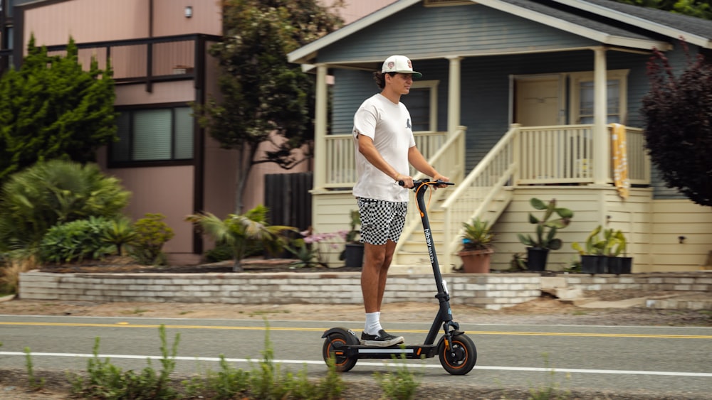 a man riding an electric scooter down a street