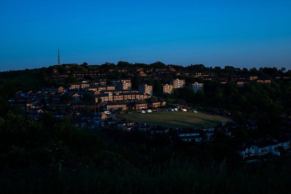 a night view of a town with a hill in the background