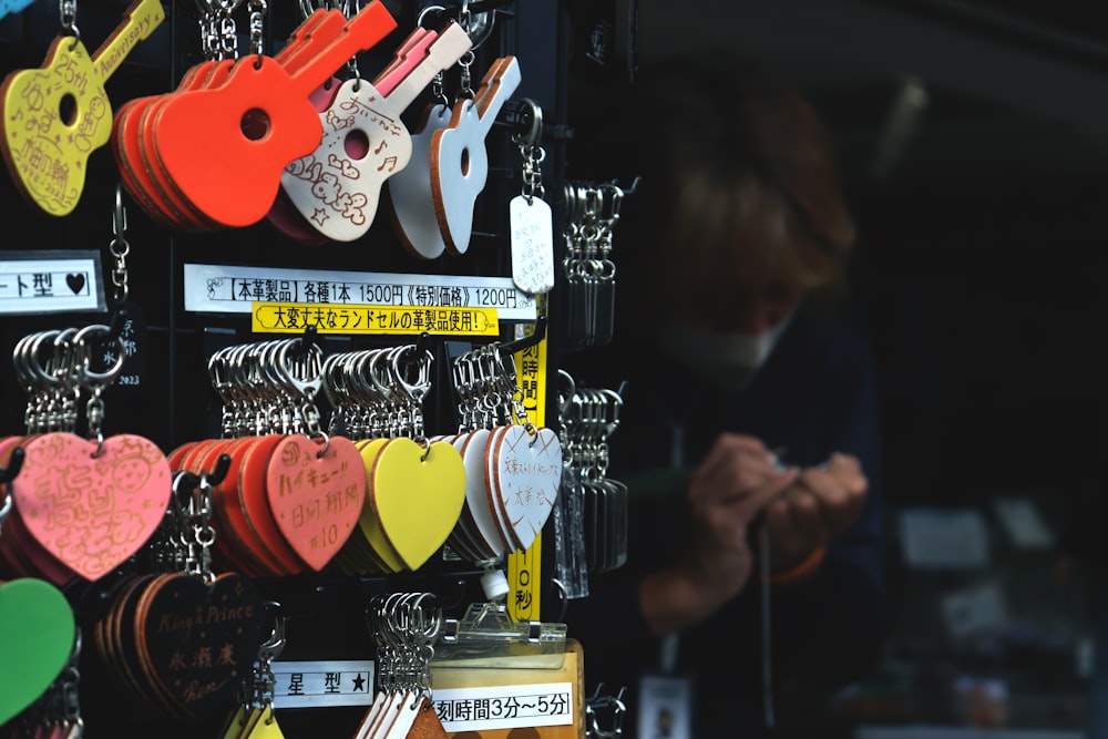 a man standing in front of a display of key chains