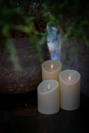 Intimate private party with warm grey candles and botanical centerpieces.
