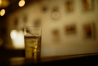 An inviting shot of a chilled beverage with condensation droplets, set against a bright, clean background