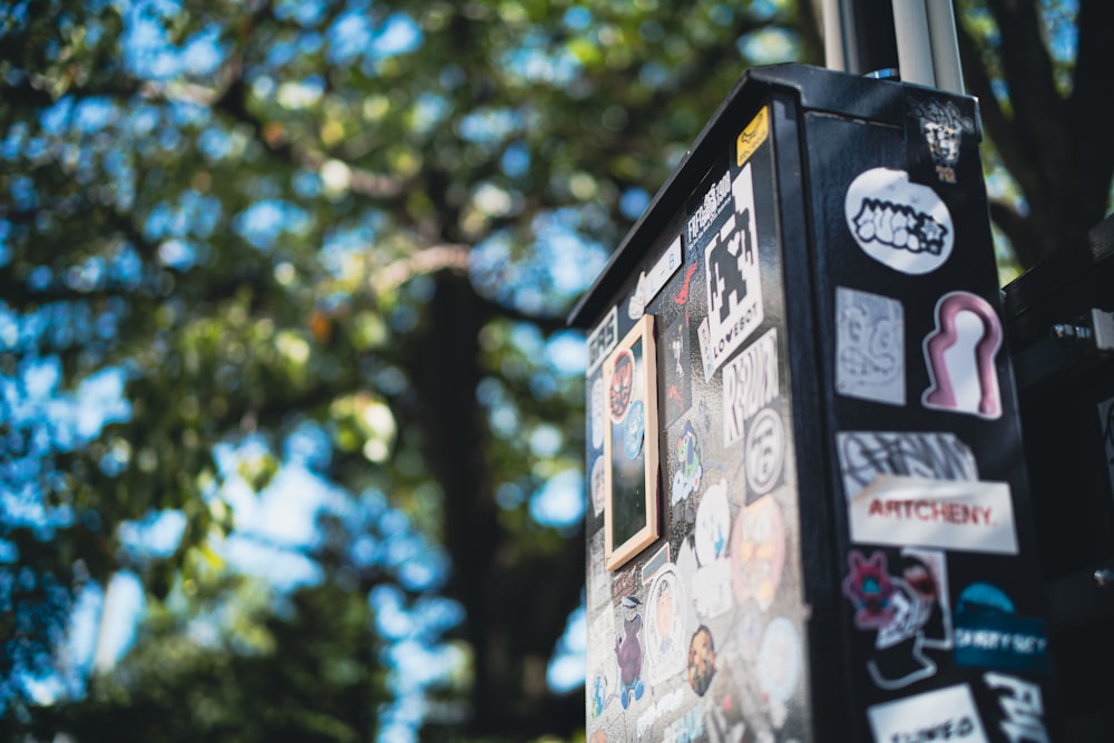 a pole with a bunch of stickers on it