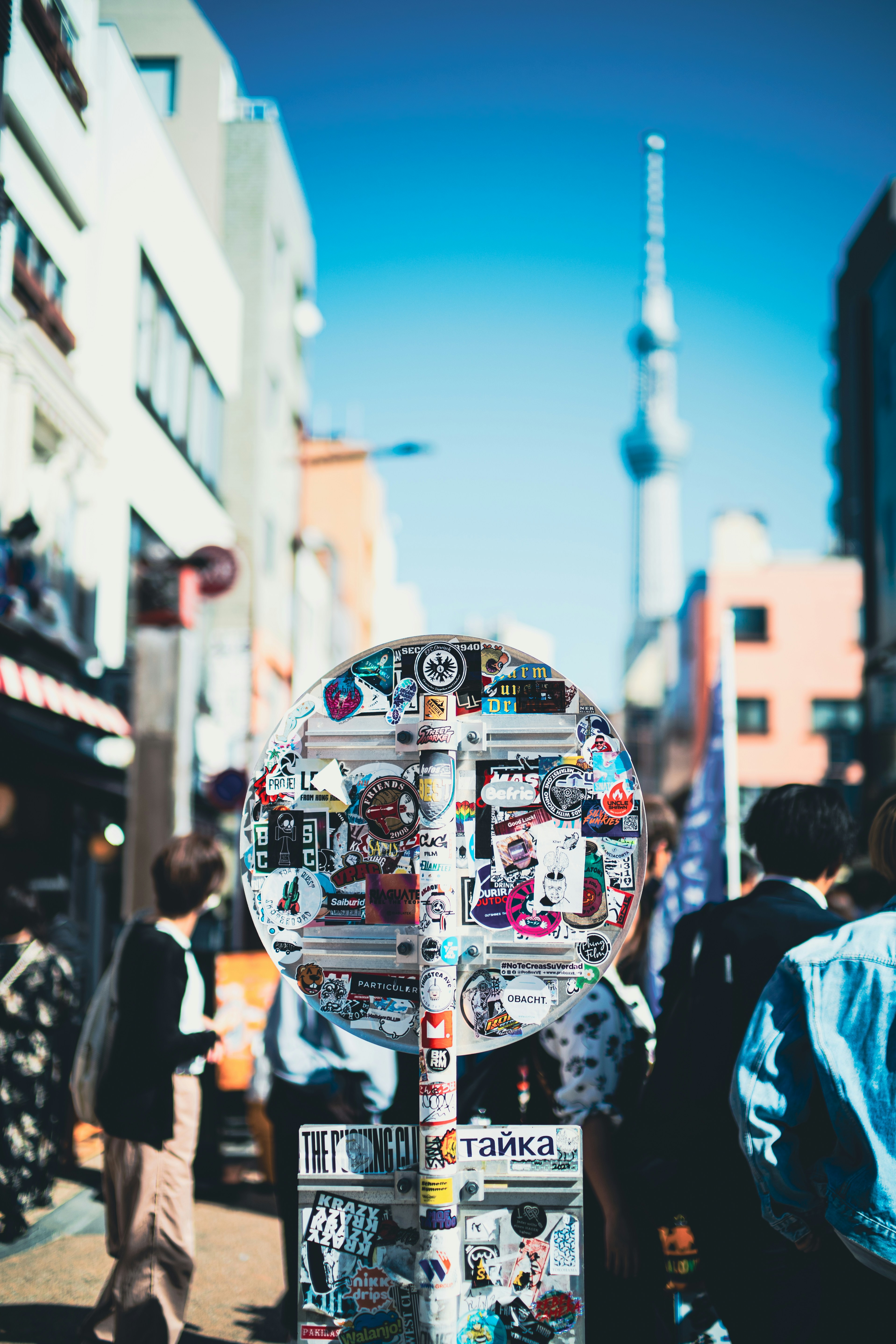 a street sign with a lot of stickers on it