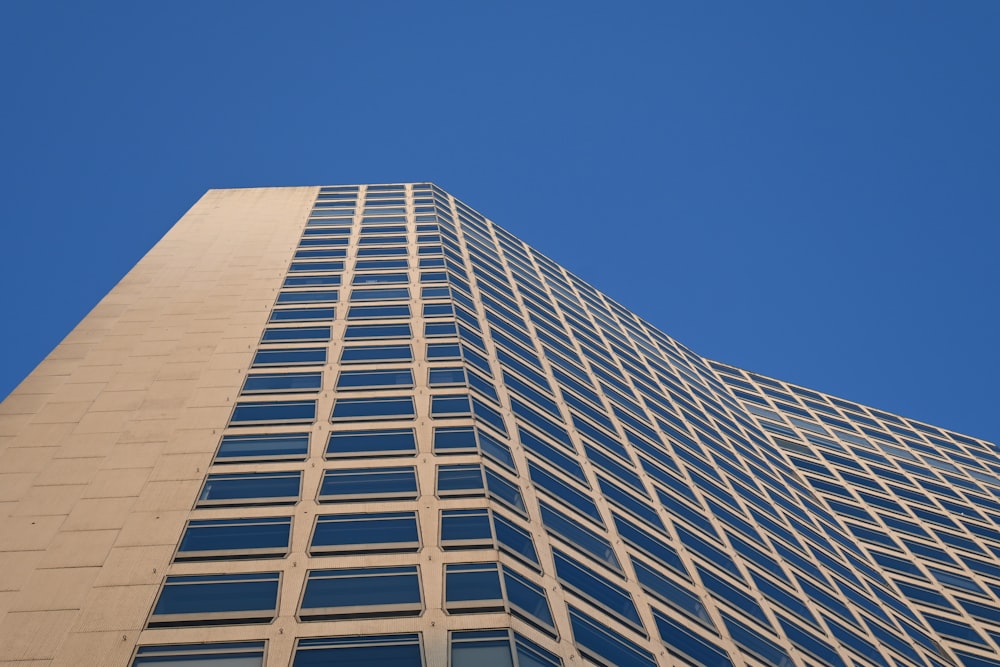 a tall building with lots of windows against a blue sky