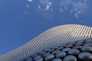 a tall building with a sky background