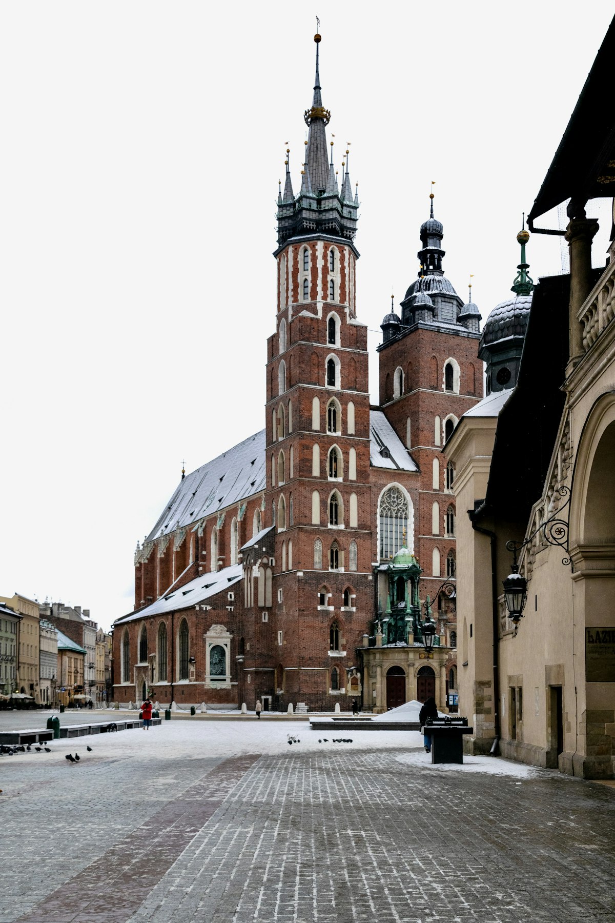 Kraków January — St Mary's Basilica in the snow, Rynek Główny market square empty in deep winter