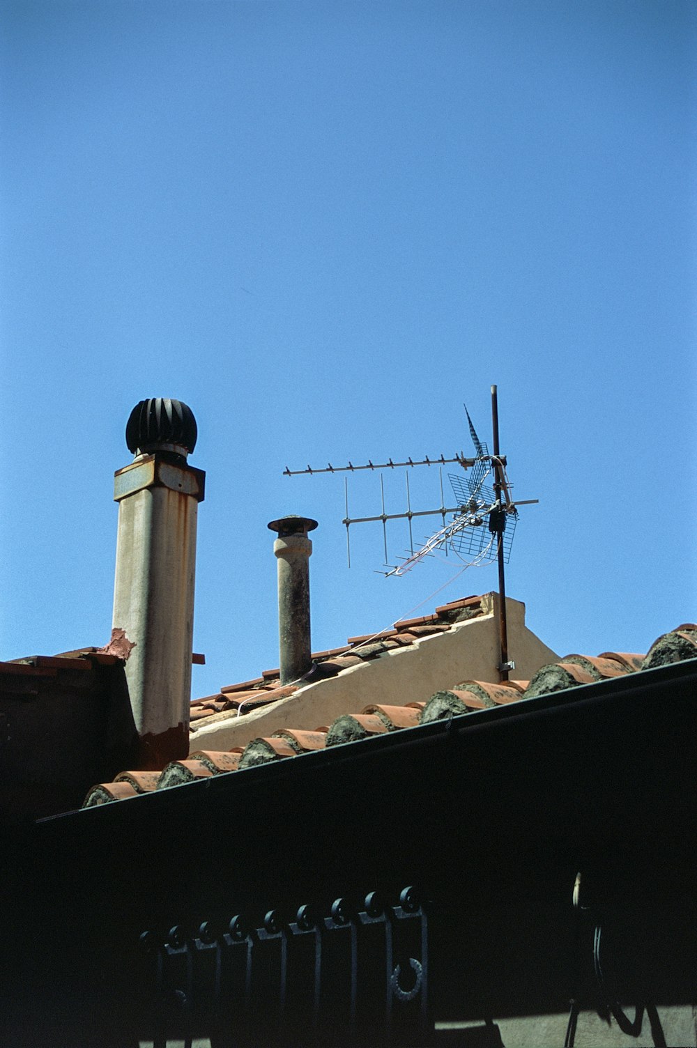 a view of a roof with a weather vane on top of it
