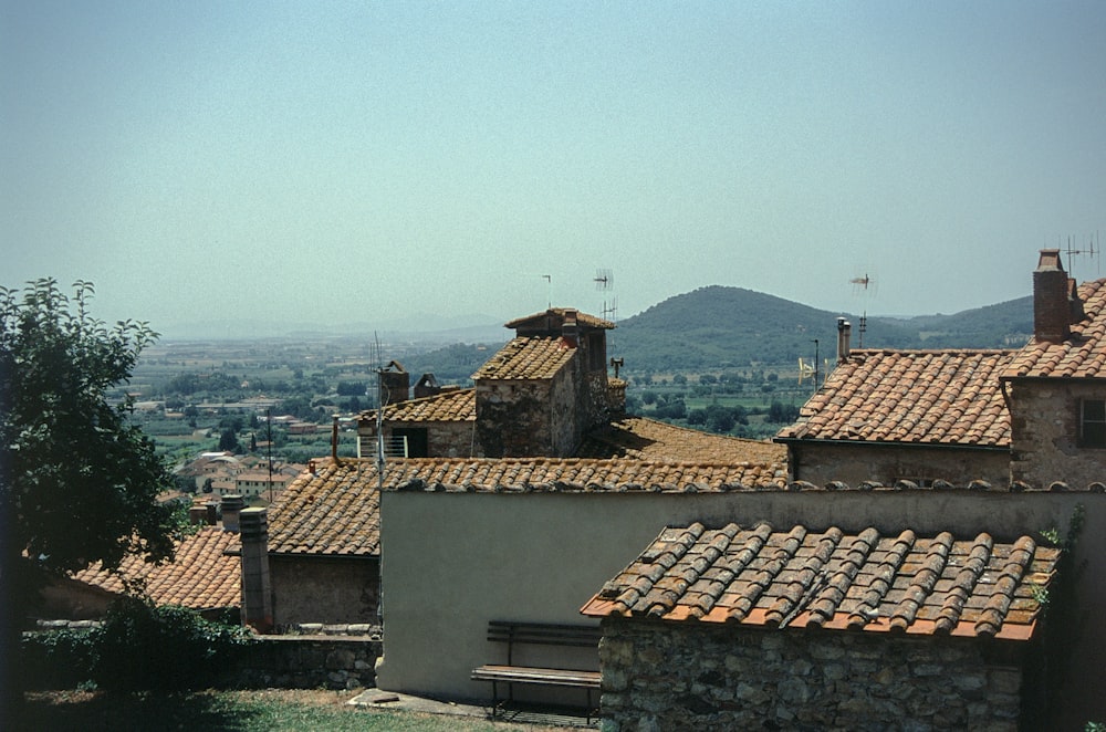 a view of a small village with a bench in the foreground