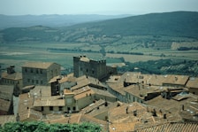 View of the medieval village from a hotel balcony with terracotta rooftops and stone streets.