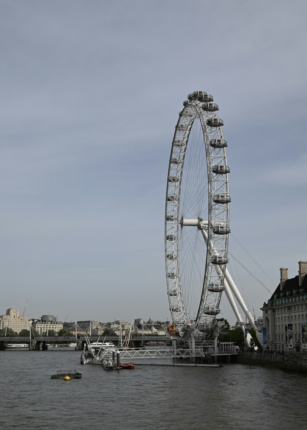 a large ferris wheel sitting on top of a river