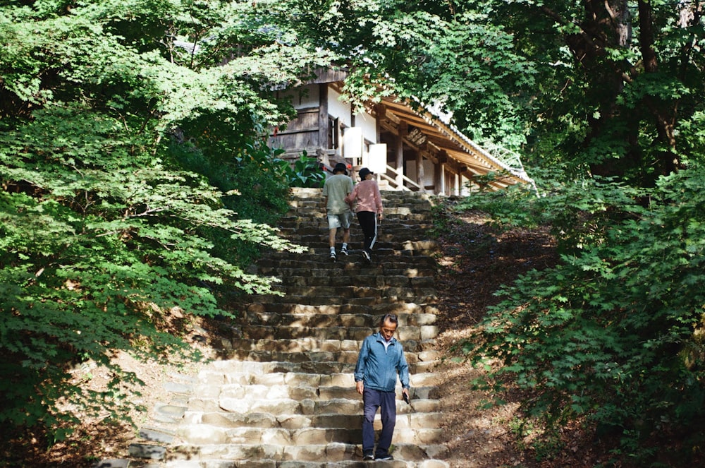 a couple of people walking up some steps