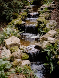 A tranquil outdoor area with natural stone and flowing water, perfect for relaxation.
